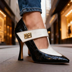 Side profile of black croc-embossed heel with cream strap, highlighting the slim heel and cut-out silhouette