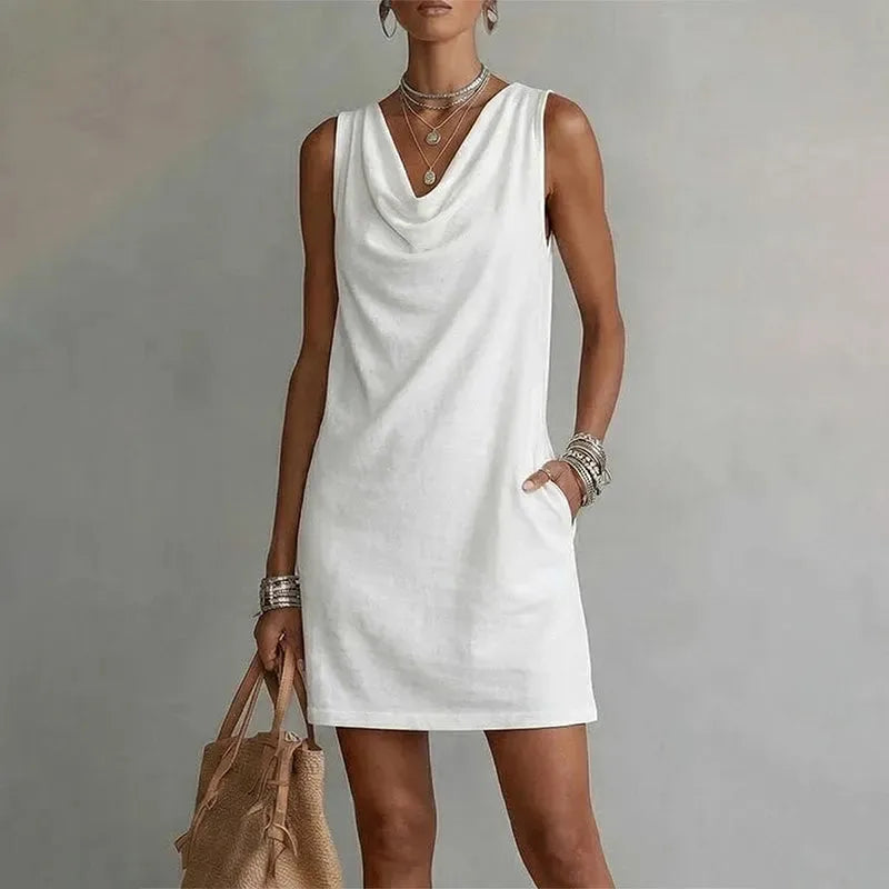 Full-length view of a sleeveless mini dress showing the loose shift shape falling above the knee