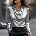 Silver grey satin blouse featuring a draped cowl neckline and point collar, paired with a black skirt