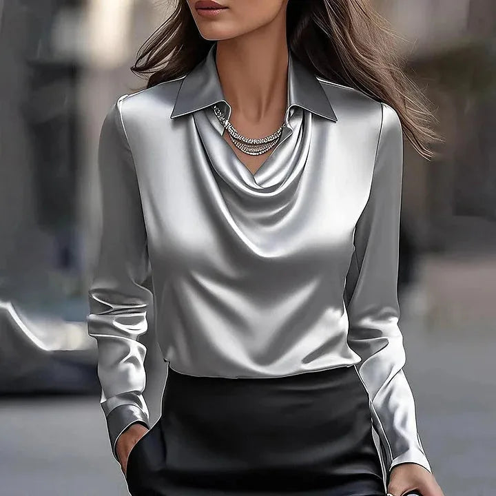 Silver grey satin blouse featuring a draped cowl neckline and point collar, paired with a black skirt