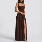 Side view of a deep brown satin maxi dress with square neckline, fitted corset bodice and asymmetric draped skirt with high slit