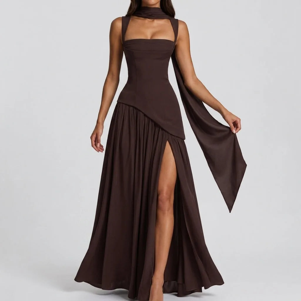 Front view of a brown satin maxi dress with a long draped scarf detail trailing from the halter neckline