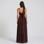 Back view of a brown satin maxi dress showing the lace-up corset back, halter strap and flowing scarf tail