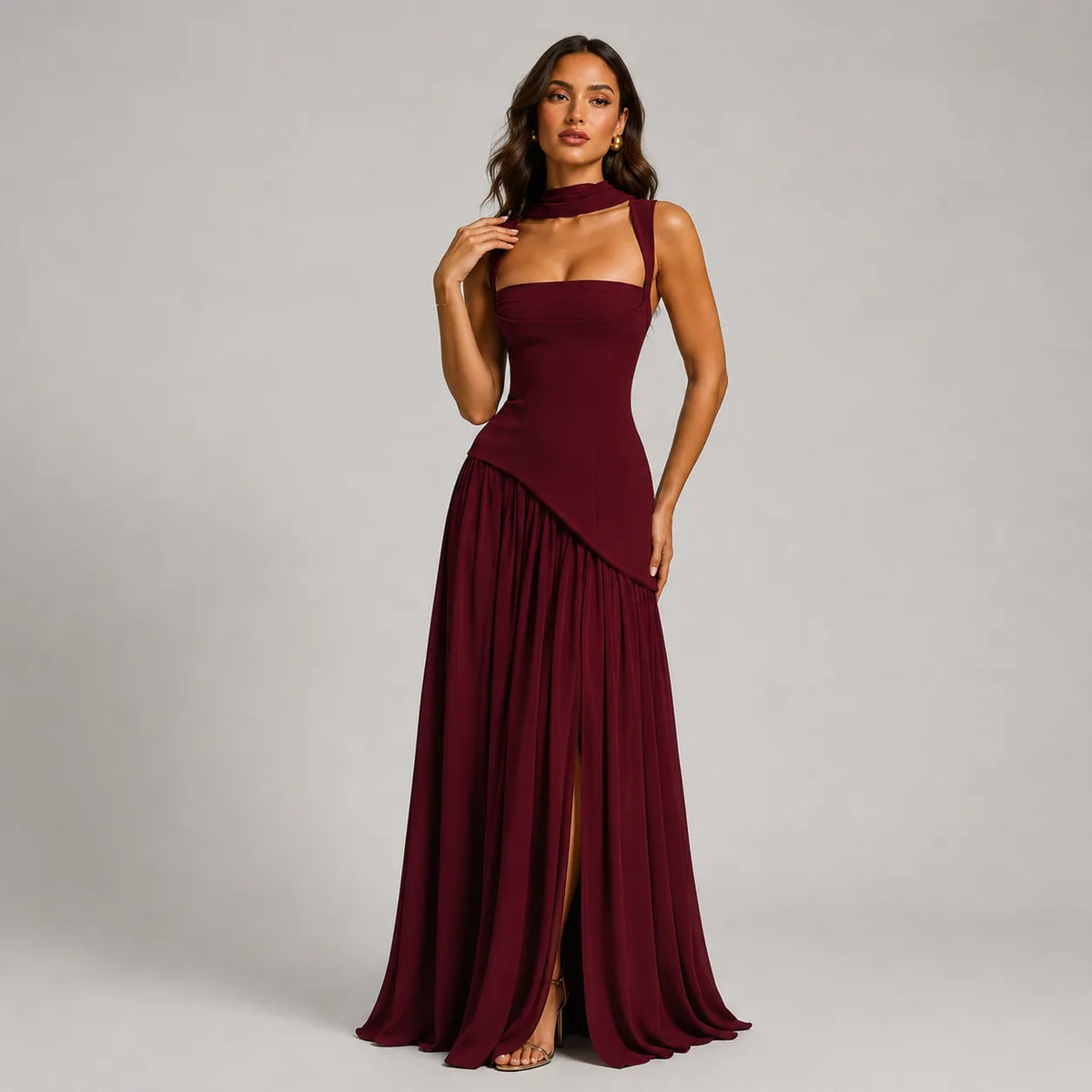 Burgundy satin-look maxi dress with sculpted bodice, square neckline and asymmetric draped skirt on a model standing