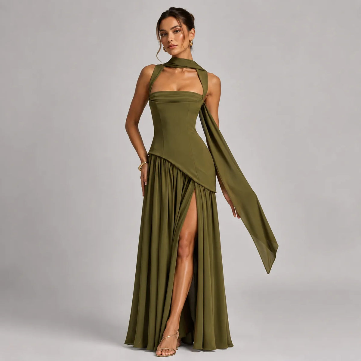 Three-quarter view of the olive green dress highlighting the draped scarf tie trailing down one arm