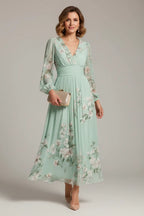 Front view of the sage green floral midi dress showing the pleated skirt, fitted waistband and V-neck bodice