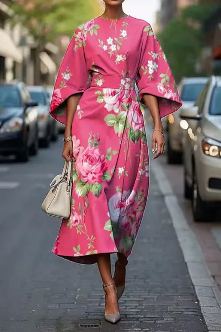 Bold pink floral kimono-sleeve midi dress with large rose print, cinched waist and flowing A-line skirt