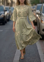 Sage green leaf-print midi dress with round neckline, belted waist and flared three-quarter sleeves