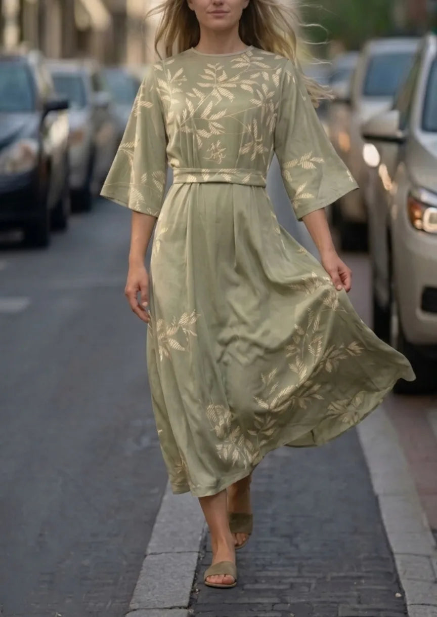 Sage green leaf-print midi dress with round neckline, belted waist and flared three-quarter sleeves