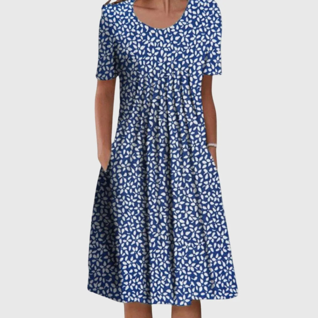 Front view of a navy blue midi dress with a small white floral scatter print, short sleeves and a relaxed A-line skirt