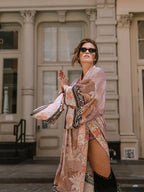 Close-up of the border trim detail on the rust orange kimono sleeve with floral and geometric pattern