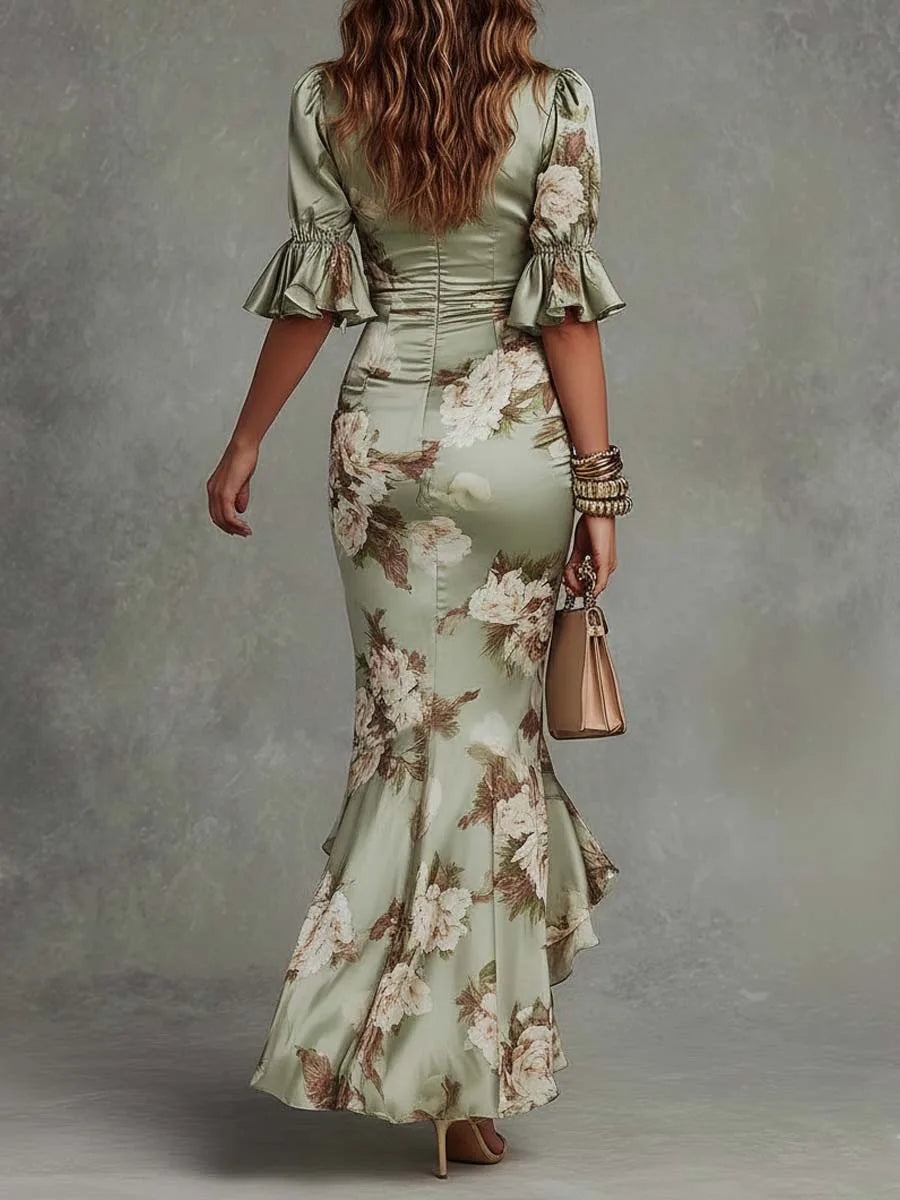Back view highlighting the fitted bodice, flounce cuffs and mermaid-style flared skirt