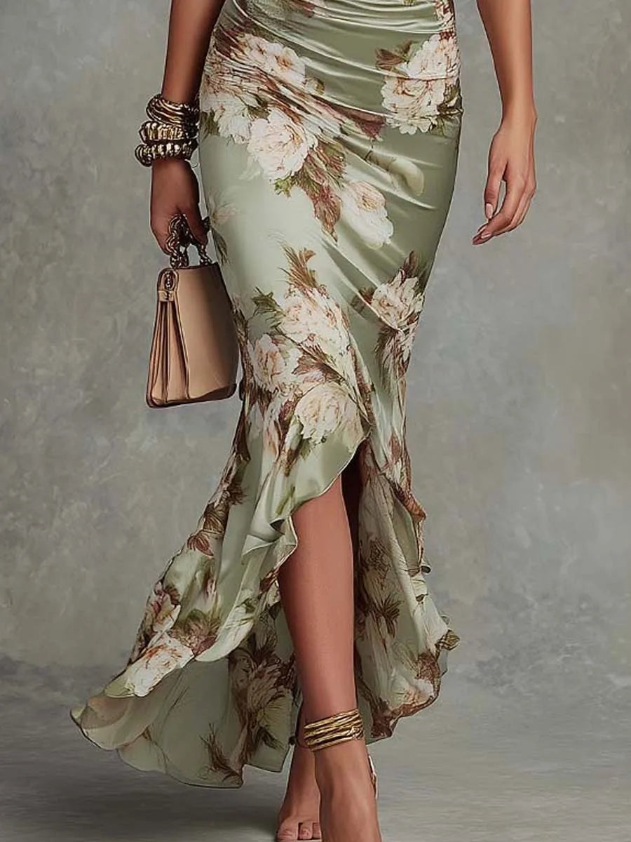 Close-up of the ruched waist and flowing asymmetrical ruffle hem of the satin dress
