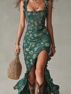 Close-up front view of the green floral dress highlighting the smocked texture, ruffle straps and ruched side slit skirt