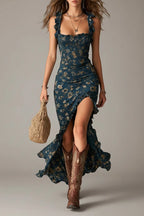 Front view of the maxi dress in a deep teal floral print, showing the fitted silhouette and ruffled mermaid-style hem