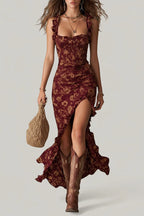 Front view of the maxi dress in a burgundy floral print, showing the smocked bodice and asymmetric ruffled skirt hem