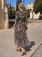 Back view of the floral maxi dress showing the blouson sleeves and ruched waist panel