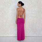Back view against a plain backdrop showing the open back, thin tie straps and rib-knit skirt of the pink dress