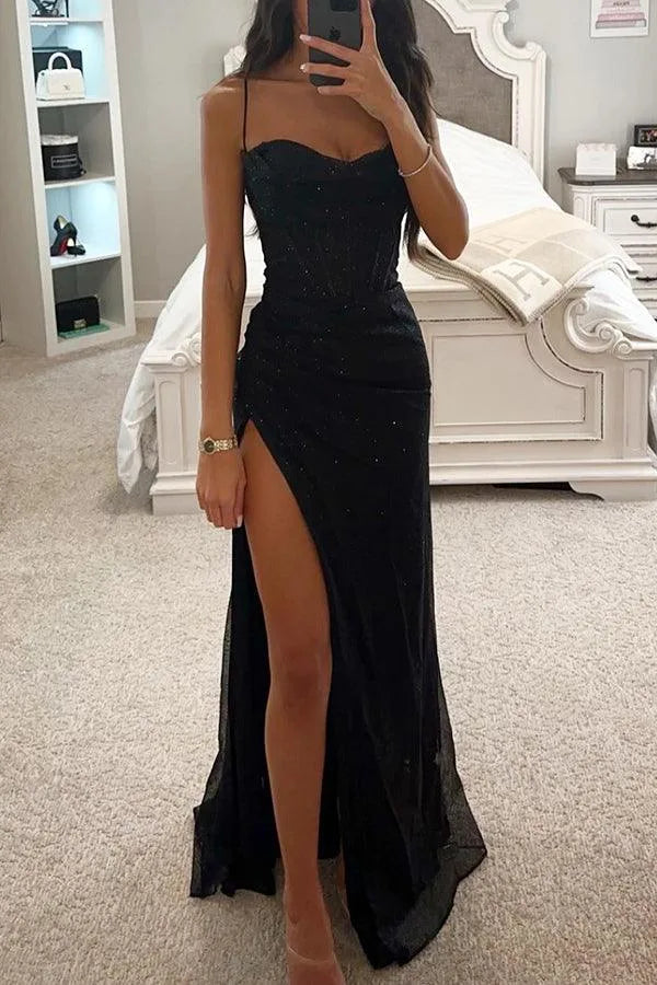 Black glitter maxi dress with corset-style bodice, thin straps and thigh-high slit, shown from the front