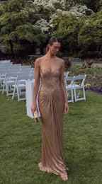 Full length front shot of gold pleated corset gown with ruched skirt detail at an outdoor garden wedding