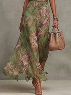 Close-up of the flowing floral maxi skirt in motion, showing the lightweight chiffon fabric and pink-green print