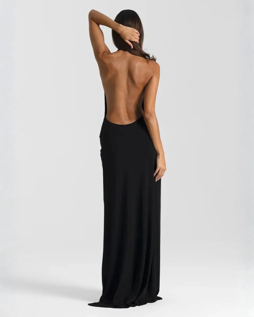 Back view of the black maxi dress showing the low open back and smooth fitted skirt