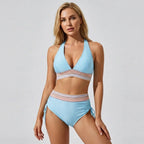 Baby blue halter neck bikini top paired with high-waisted ruched bottoms and striped trim detail