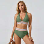 Green halter bikini set with contrast striped waistband, worn with a woven straw tote bag