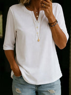 Front view of a white Henley-collar tee with four buttons, half sleeves and a curved hem