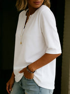Side profile of a white Henley top showing the half-sleeve cuff and soft drape along the torso