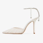 Side profile of the ivory mesh stiletto heel showing the pointed toe, slim heel and hanging crystal charm