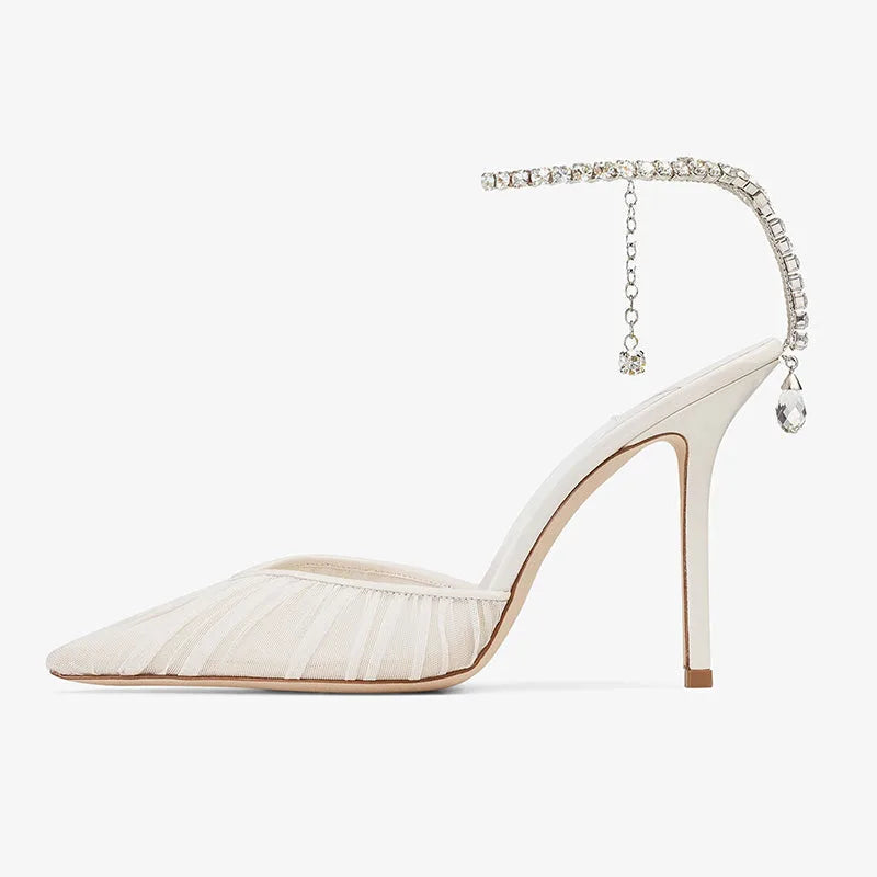 Side profile of the ivory mesh stiletto heel showing the pointed toe, slim heel and hanging crystal charm