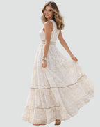 Side-back view capturing the movement of the lace maxi dress and its tiered, flowing silhouette