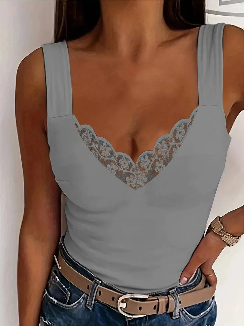 Grey sleeveless top with delicate floral lace trim shown against a plain white wall