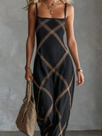 Close-up front view of black textured maxi dress with gold diamond stitching and spaghetti straps