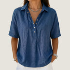 Close-up front view of a navy blue linen-look blouse with collared neckline and button placket