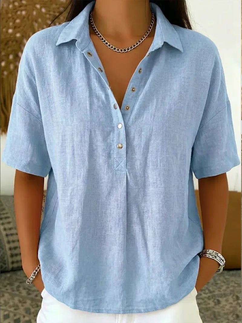Close-up of a light blue collared blouse with button front and dropped shoulder seams