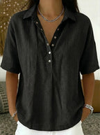 Black collared linen-blend blouse with button placket, close-up front view on a model