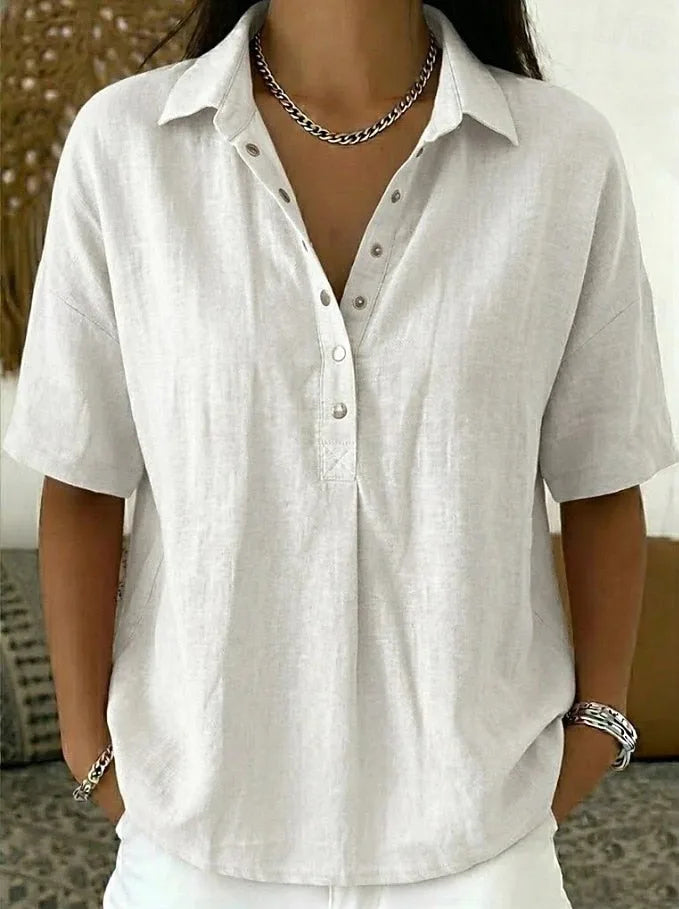 White collared linen-look blouse with button front, shown with layered necklaces and white pants