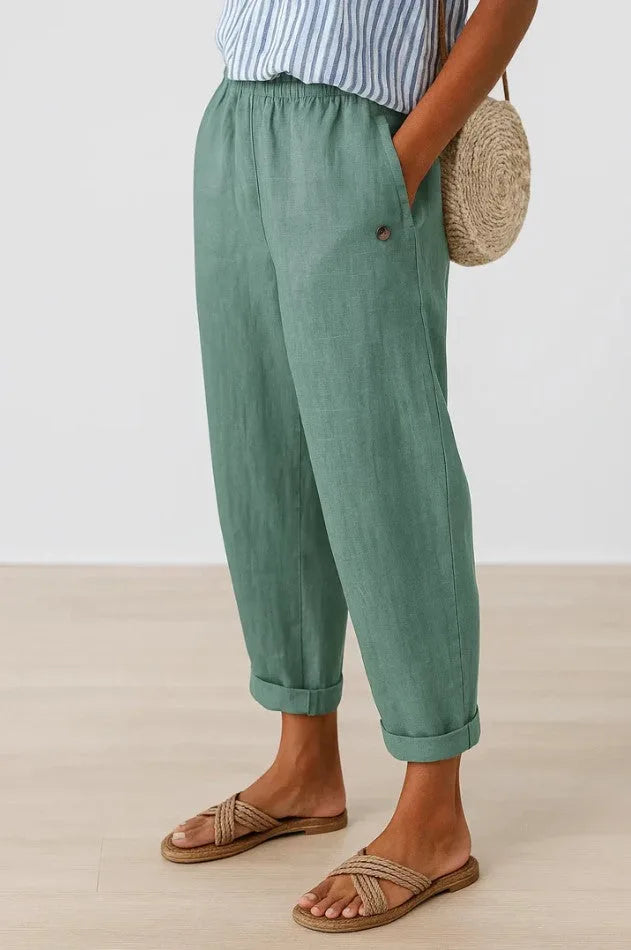 Sage green cropped trousers with cuffed ankle hem, relaxed balloon leg silhouette and side pocket