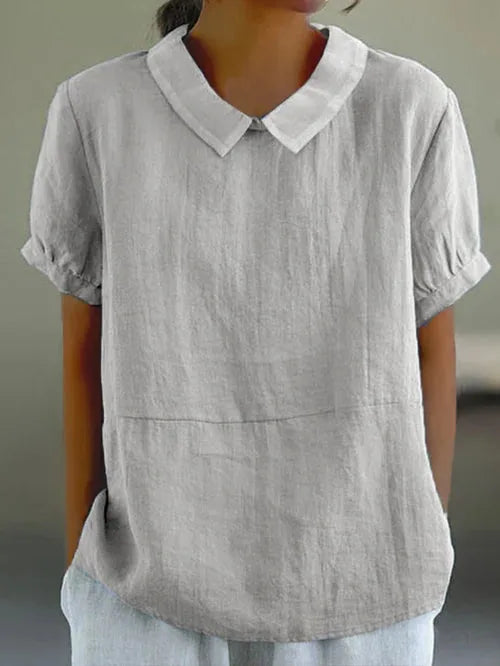 Light grey linen-blend blouse with folded collar and cuffed short sleeves, front torso view