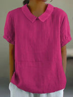 Dark pink (magenta) linen-look blouse with round collar and short puff sleeves, close front view