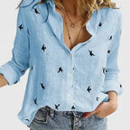 Soft blue linen shirt shown from the front highlighting the relaxed straight fit and curved hemline