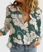 Light green linen shirt with button-down front, styled casually over high-waisted denim shorts