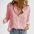 Pink linen button-down shirt with wavy collar detail, buttoned halfway to show a relaxed V-neckline