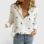 Model wearing an off-white linen shirt with sleeves pushed up, hand resting in denim pocket