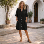 Black linen shirt dress shown from the front, highlighting the button placket, relaxed shape and knee-skimming hemline.