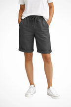 Front view of charcoal grey linen-look shorts with drawstring waist, side pockets and cuffed leg hems