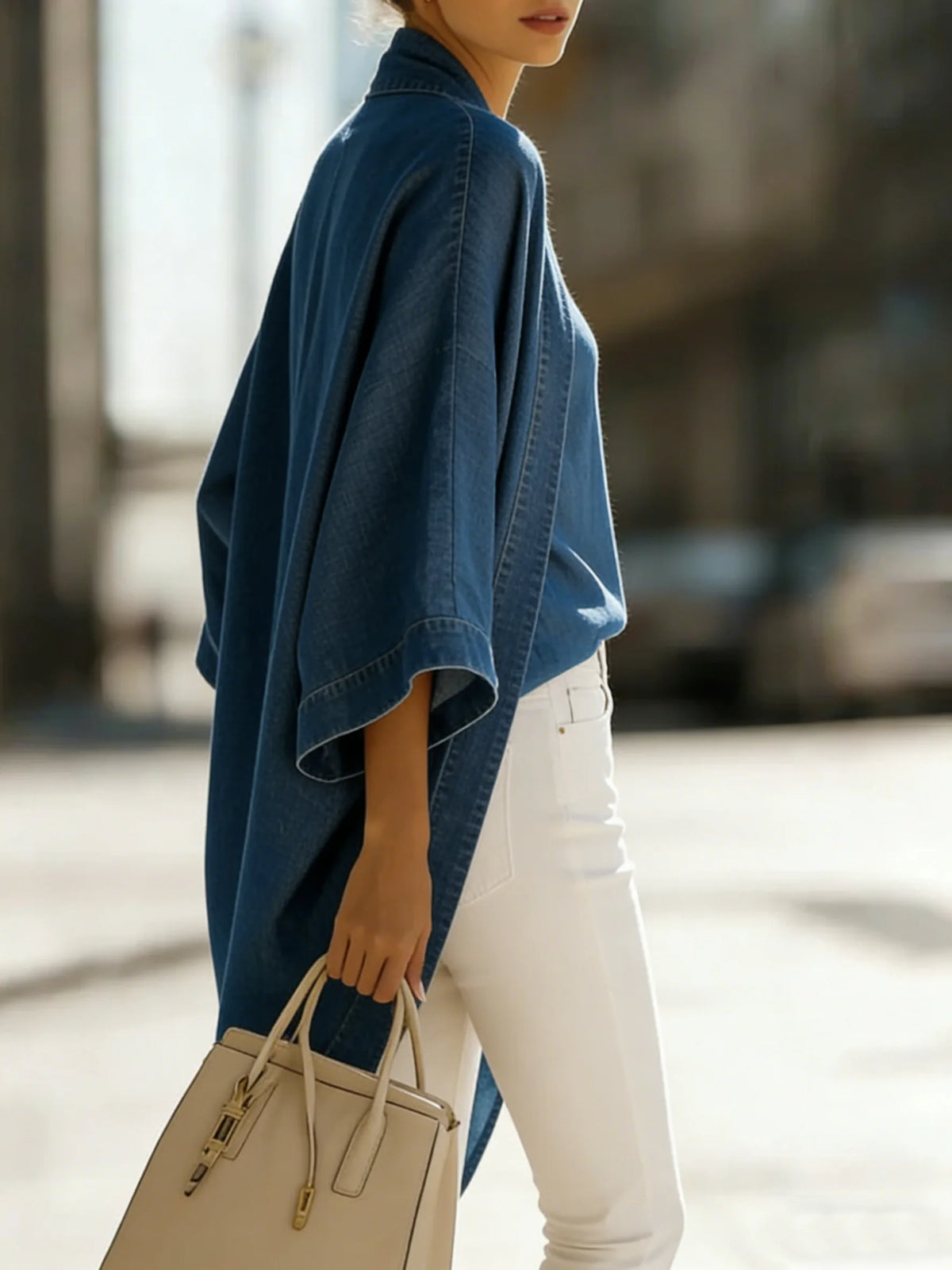 Side profile view of the oversized kimono cardigan highlighting the wide kimono sleeves and relaxed, draped silhouette