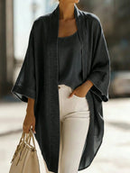 Charcoal grey chambray kimono cardigan worn open over a matching camisole top, paired with white jeans for a street style look